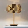 Designer-deformable-candeeiro-de-mesa-moderno-ouro-a-o-inoxid-vel-candeeiro-de-mesa-sala-estar Abajur Contemporâneo 2024/2025 Design 3D Aço Inoxidável Dourado miresa