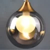kf-S9f0b92c9a73142c696ac50964a4cfca4a-Moderno-conduziu-a-l-mpada-de-parede-vidro-bola-ouro-arandela-ilumina-o-interior-nordic-sala Luminária Parede Barcelona Bola Vidro