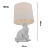 kf-H6e1d35495c634888ad84dbbb742e2893Q-Lumin-ria-de-mesa-moderna-com-estampa-de-coelho-l-mpada-de-resina-criativa-com-desenho Abajur Escultura De Coelho Branco ou Preto Com Cúpula Tecido Liso
